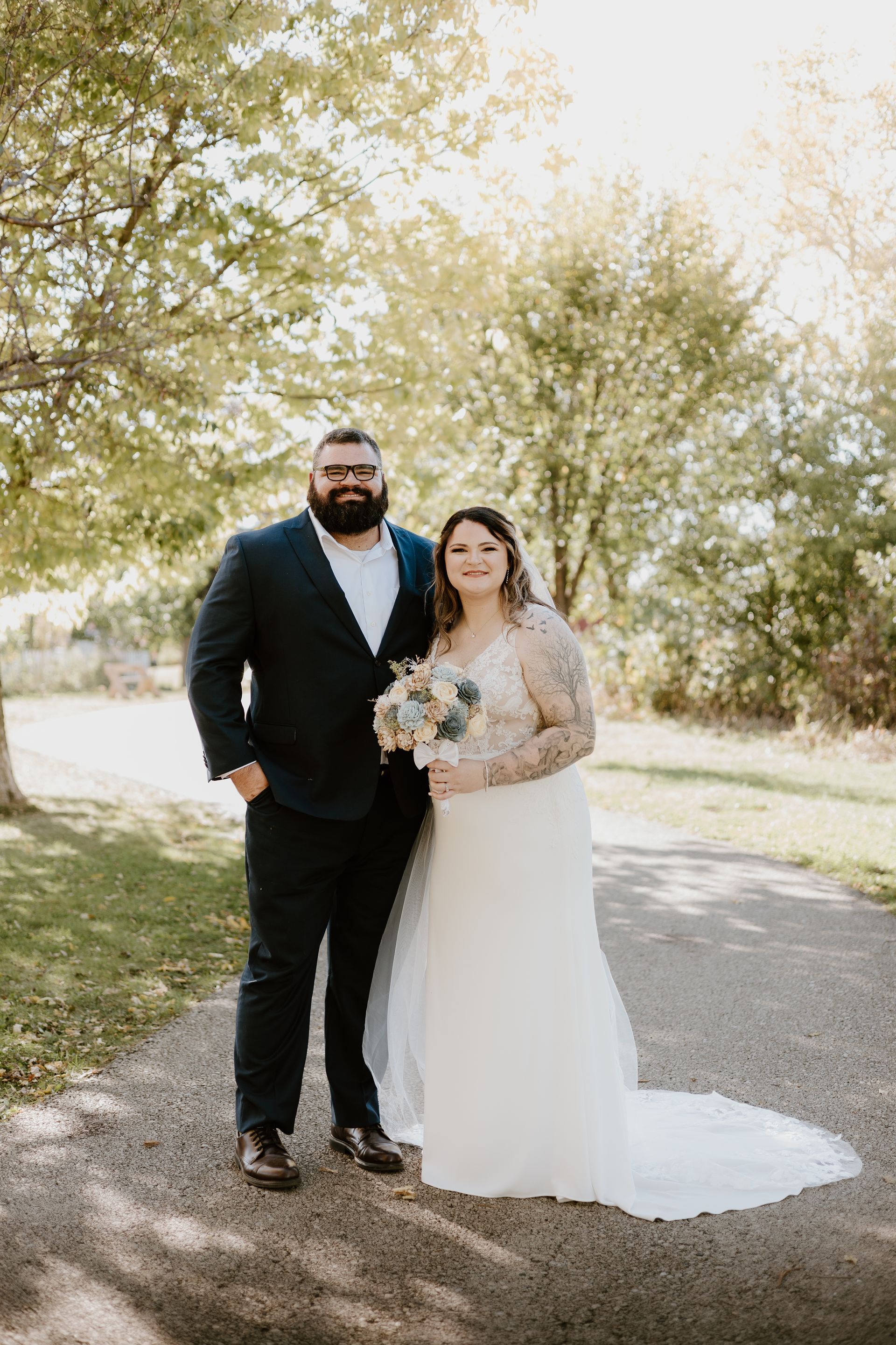 A bride and groom are posing for a picture on their wedding day.