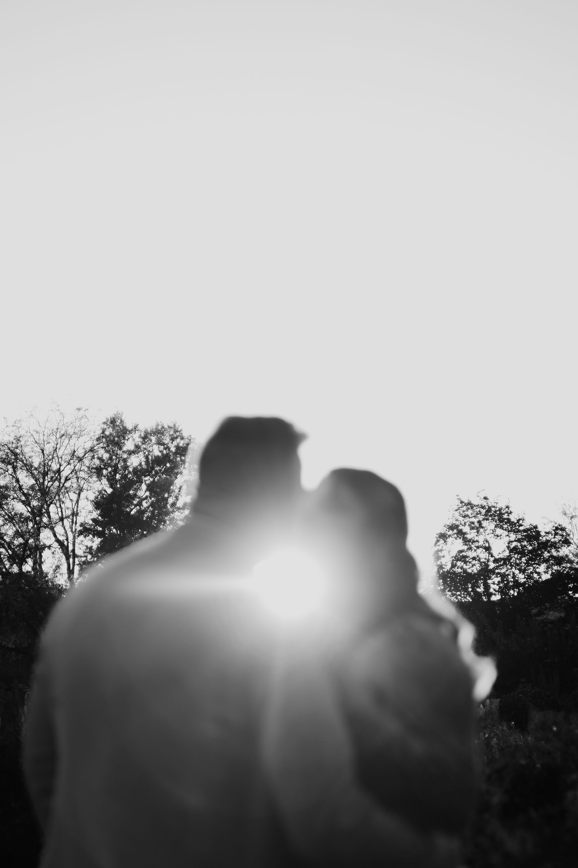 A black and white photo of a man and woman hugging each other.