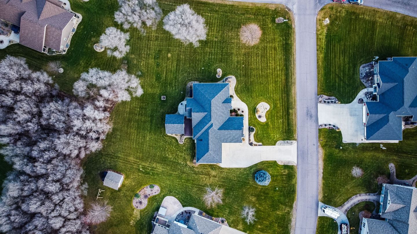 An aerial view of a residential neighborhood with houses and trees.