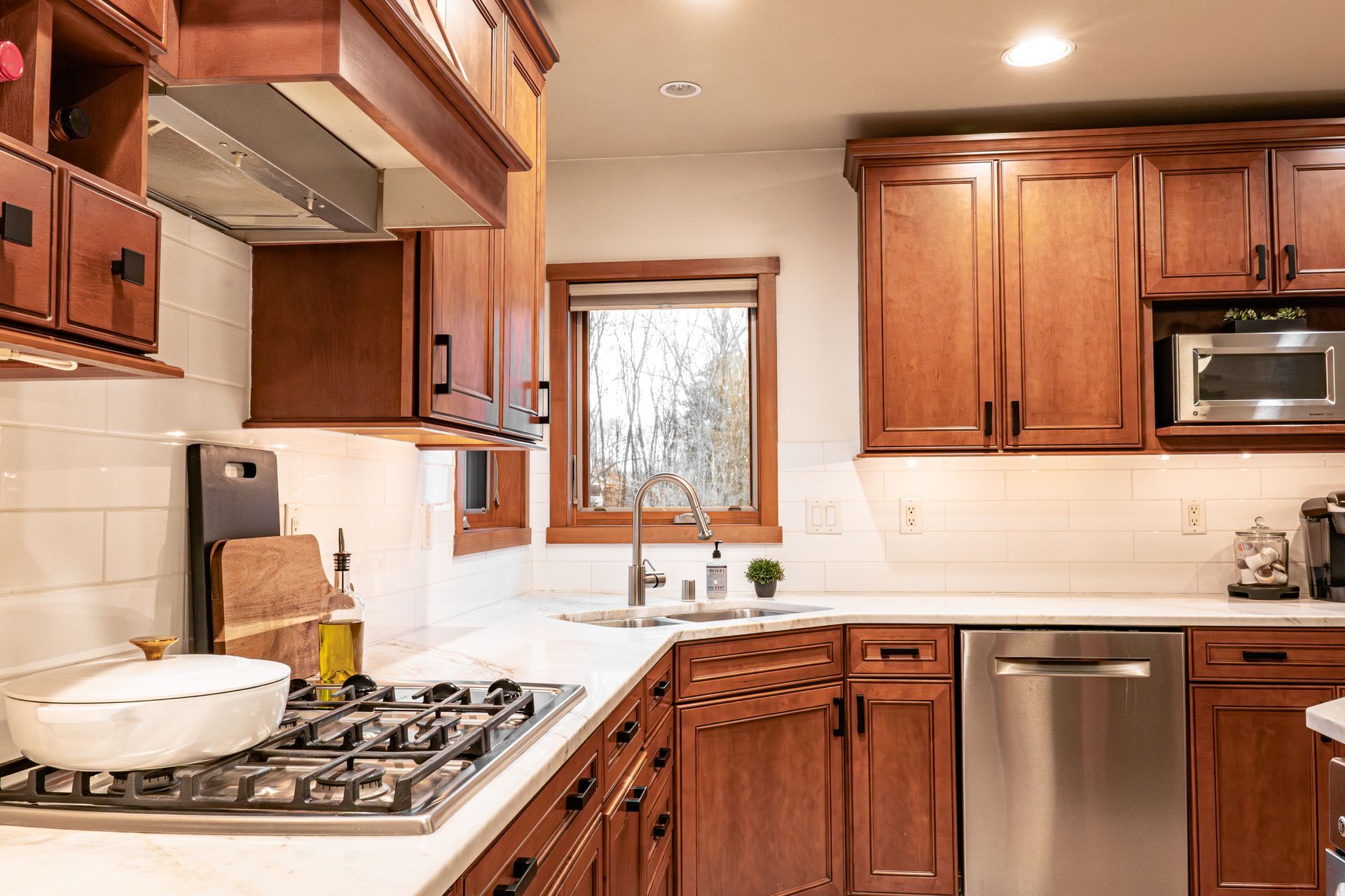A kitchen with wooden cabinets and stainless steel appliances.