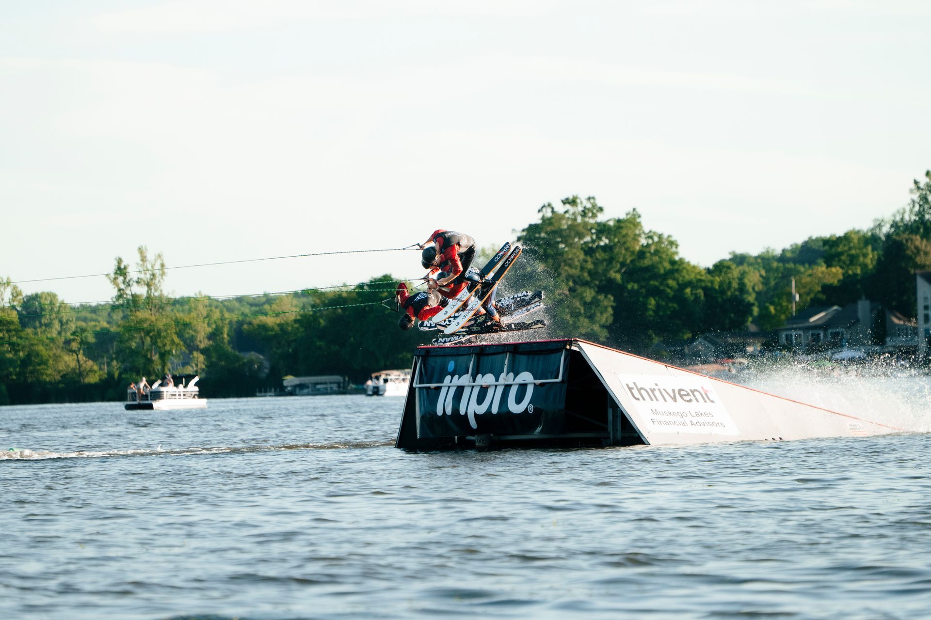 A person is doing a trick on a wakeboard in the water.