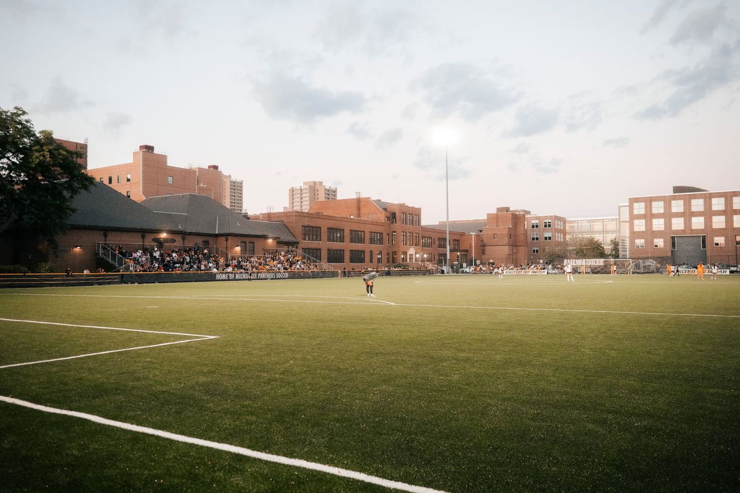 A football field with a few buildings in the background