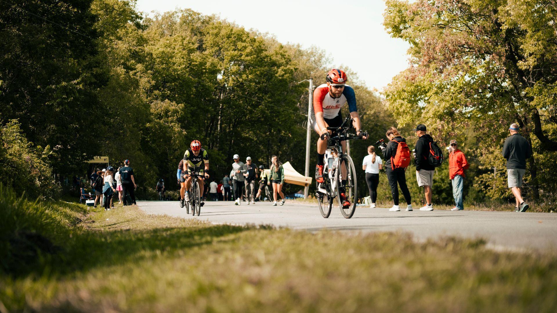 A group of people are riding bicycles down a road.