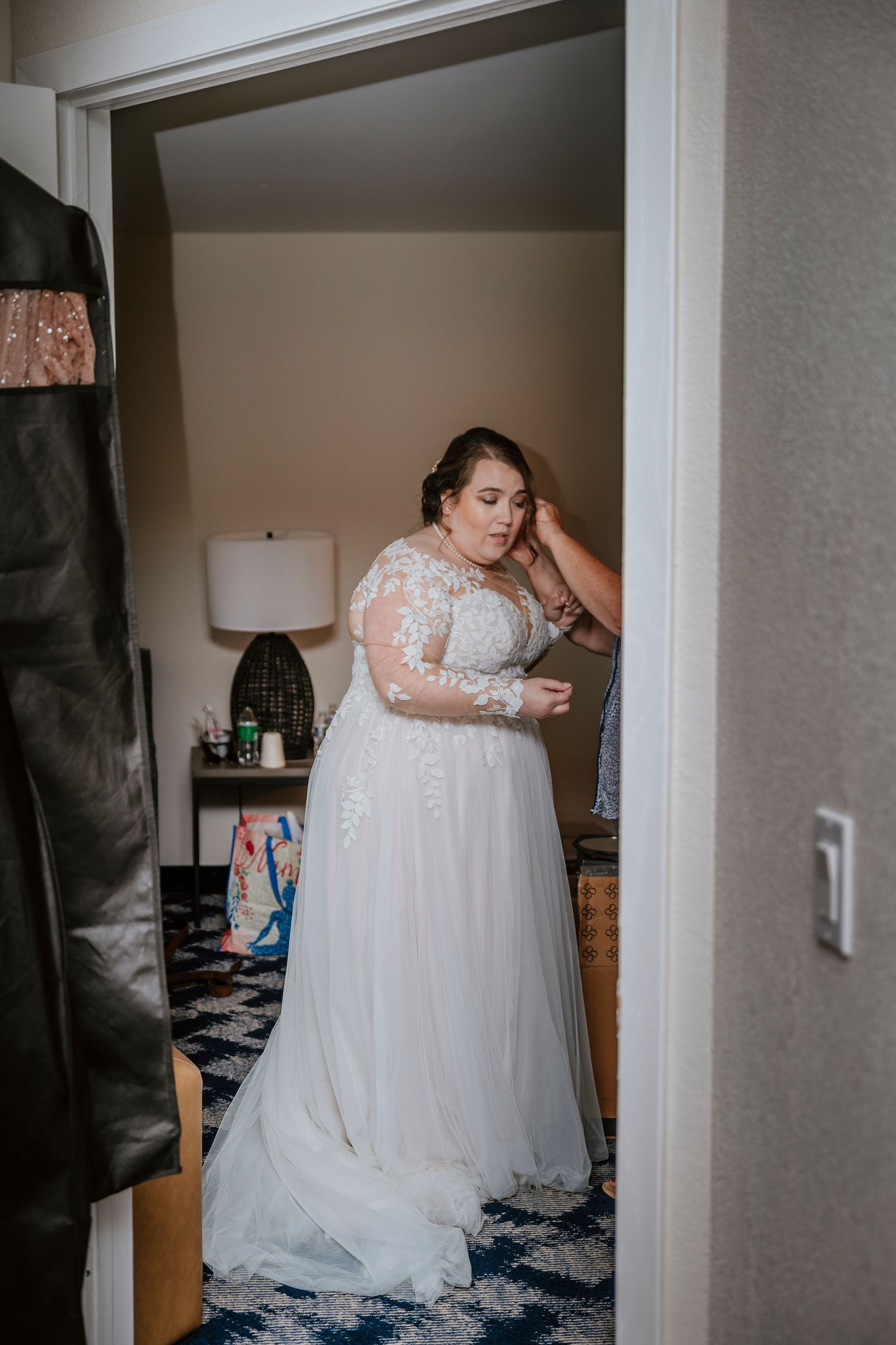 A bride is getting ready for her wedding in a hotel room.