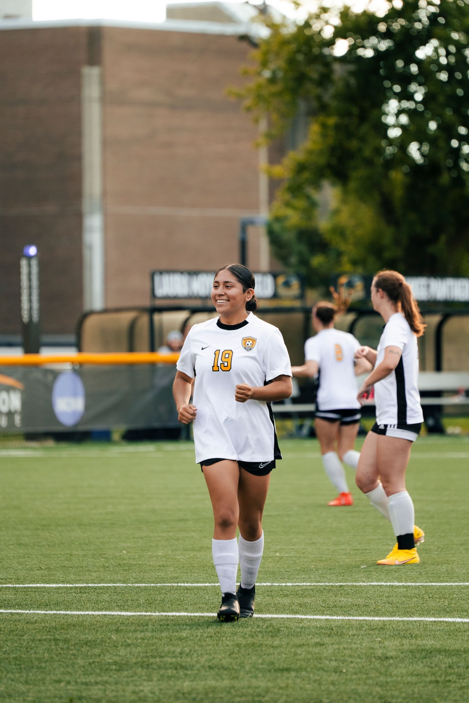 A group of women are playing soccer on a field.