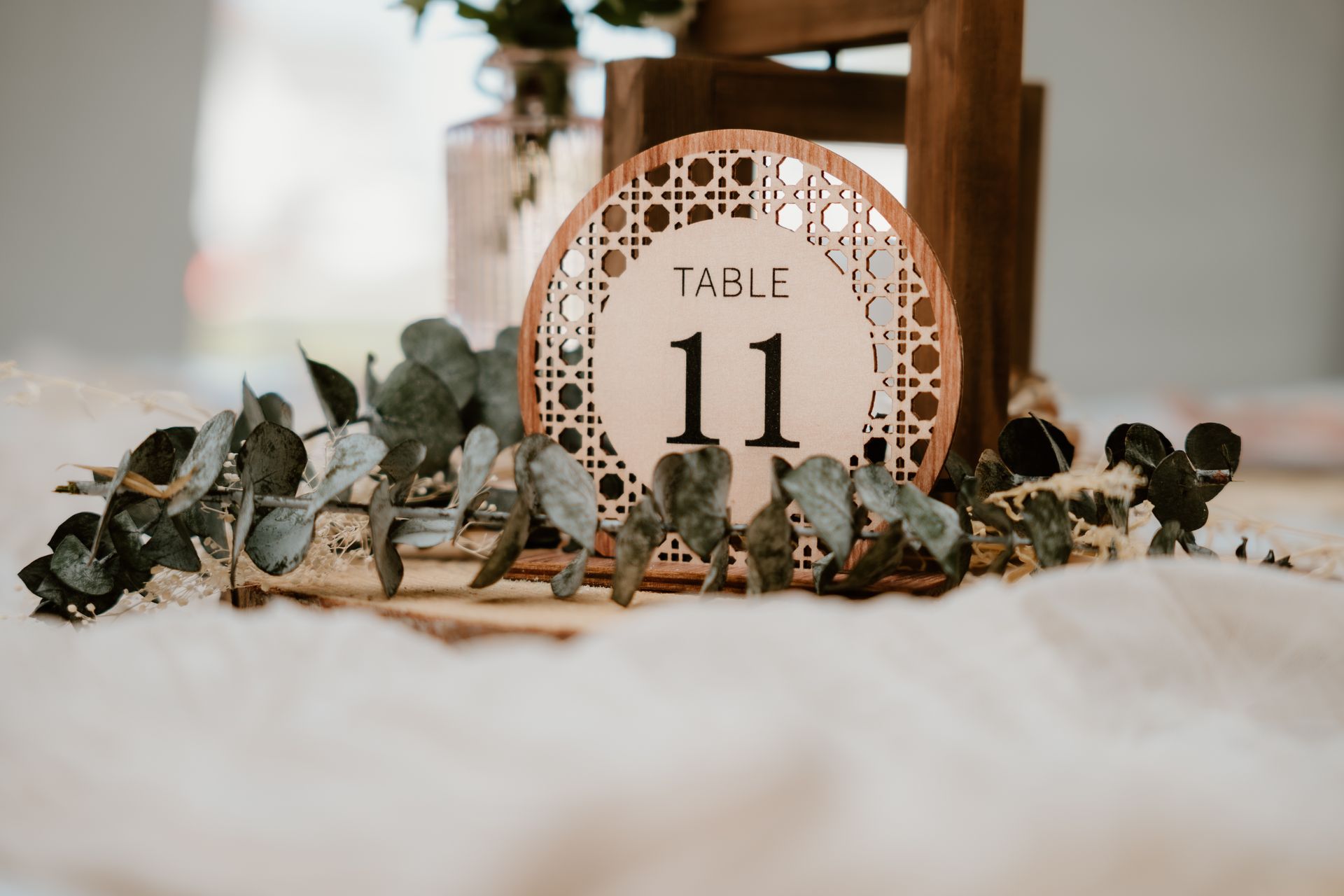 A table number 11 is sitting on a table next to a wooden chair.