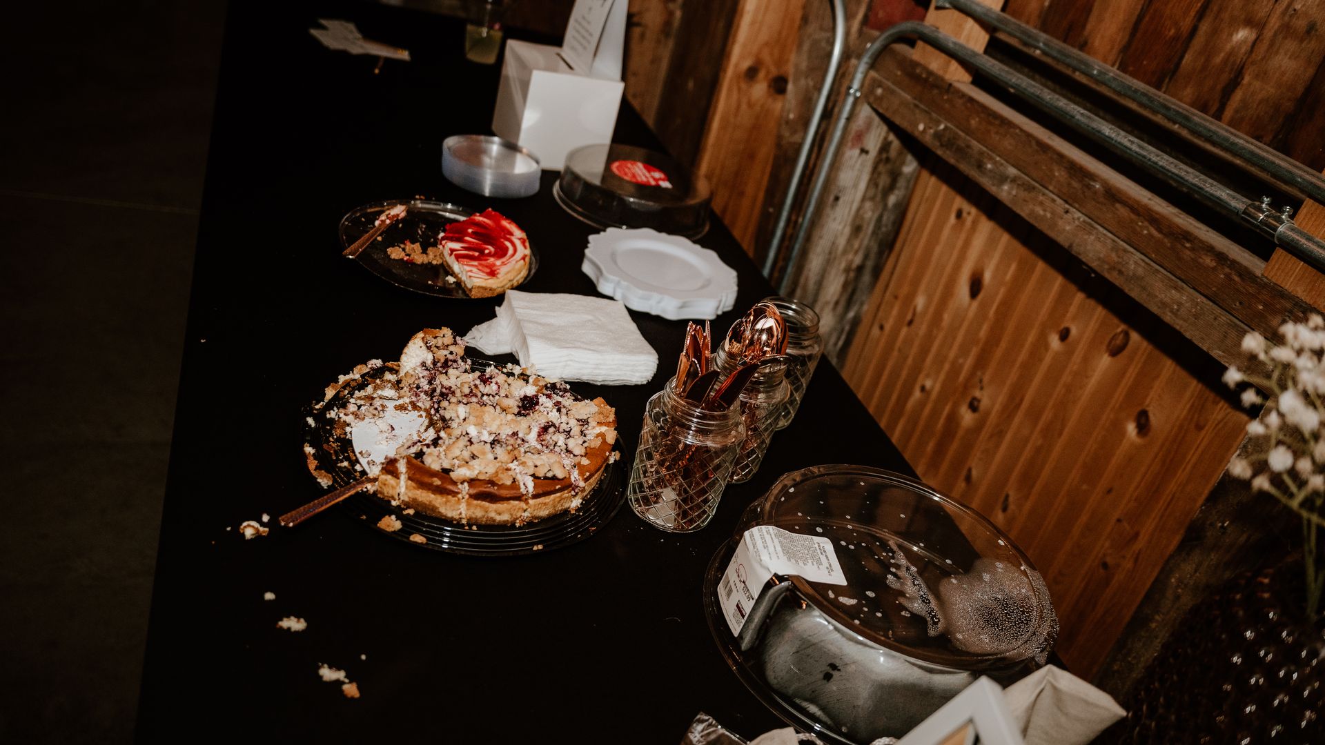 A table topped with plates of food and a few pieces of cake.