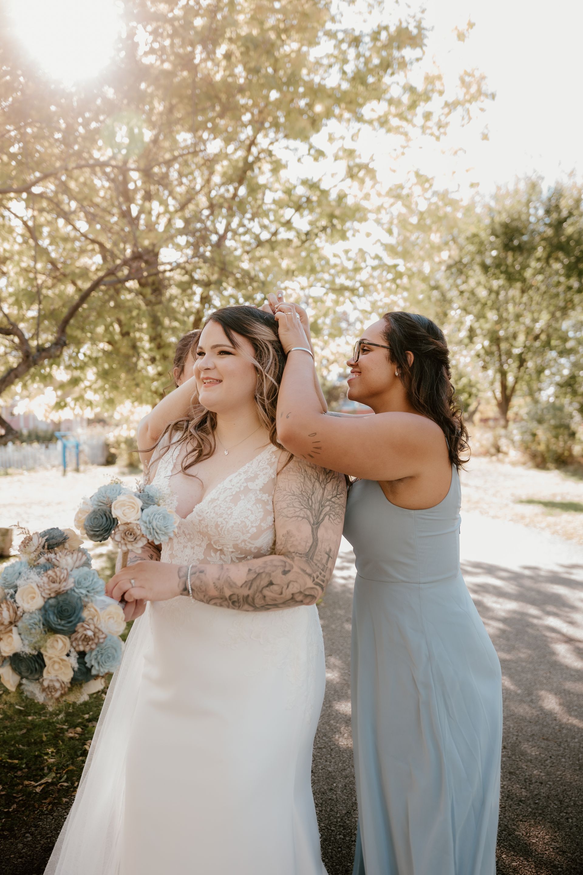A bride and her bridesmaid are getting ready for their wedding.