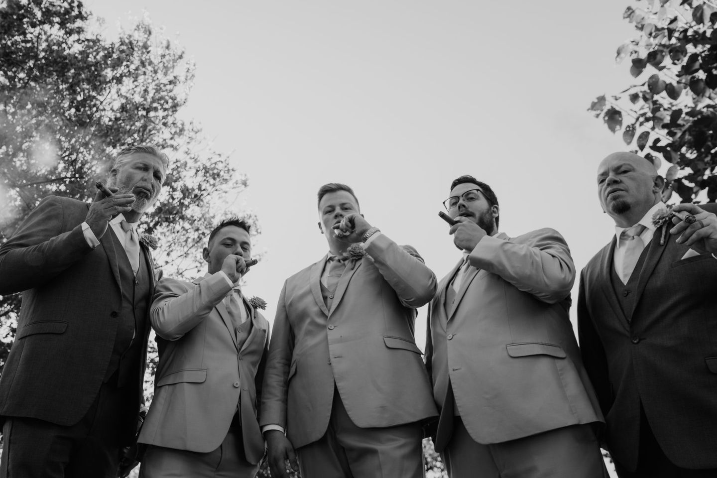 A black and white photo of a group of men in suits drinking champagne.