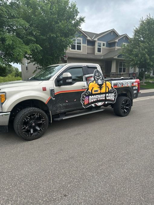 A white truck is parked in front of a house.