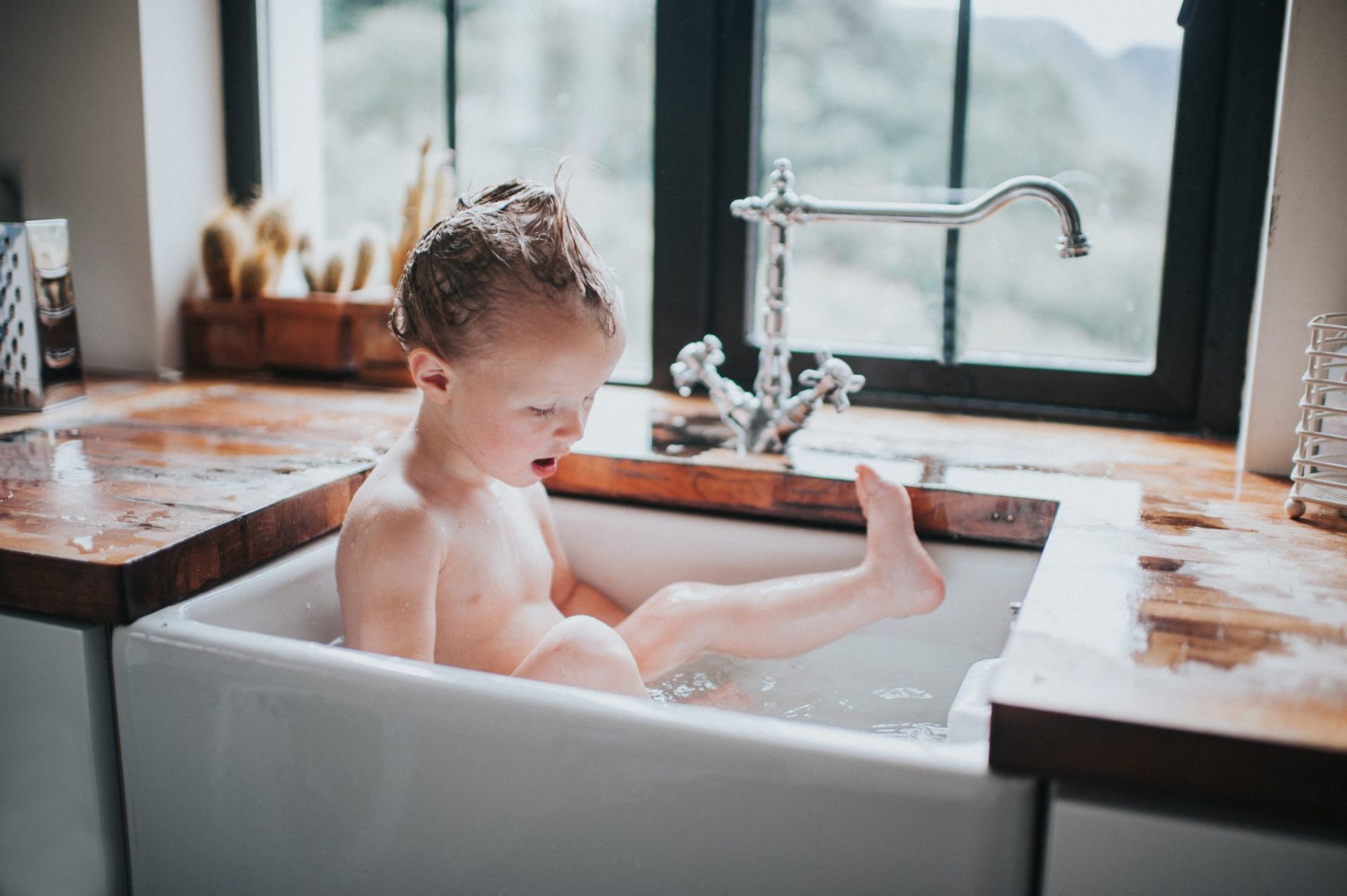 Baby in sink taking a bath