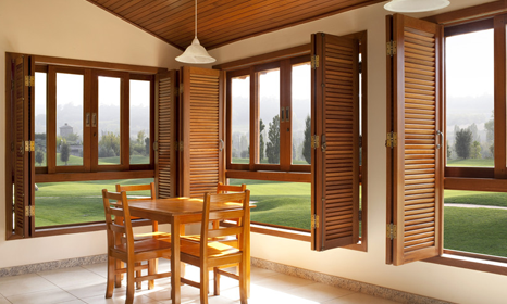 Stunning wooden doors, windows and dining set with a scenic view