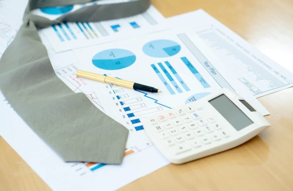 A Tie a Pen and A Calculator Are on A Table — Blue Orchid Accounting In Woongarrah, NSW