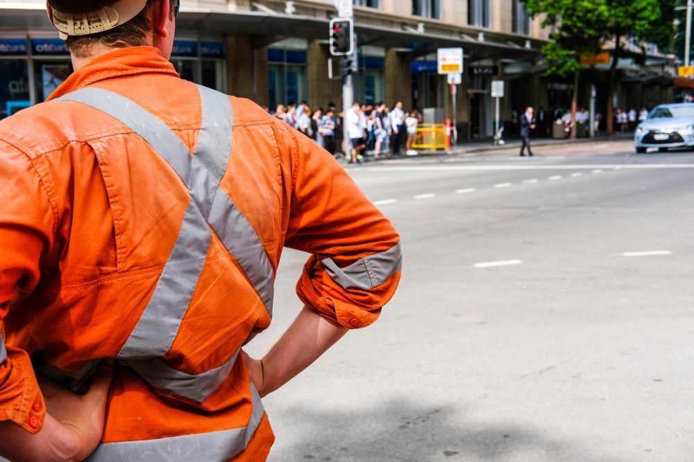 Tradie in Uniform Standing in The Street