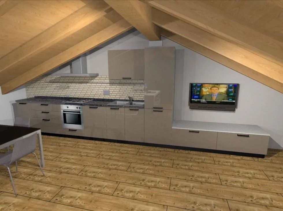 Cucina con soffitto spiovente, mobili, elettrodomestici e TV montata.