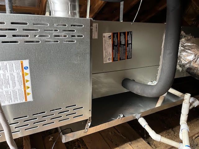 An air conditioner is installed in the attic of a house.