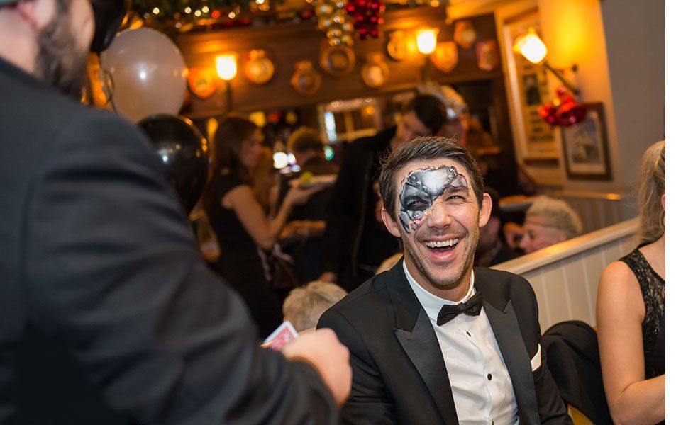 Guests reacting to a close-up magic performance in Bristol