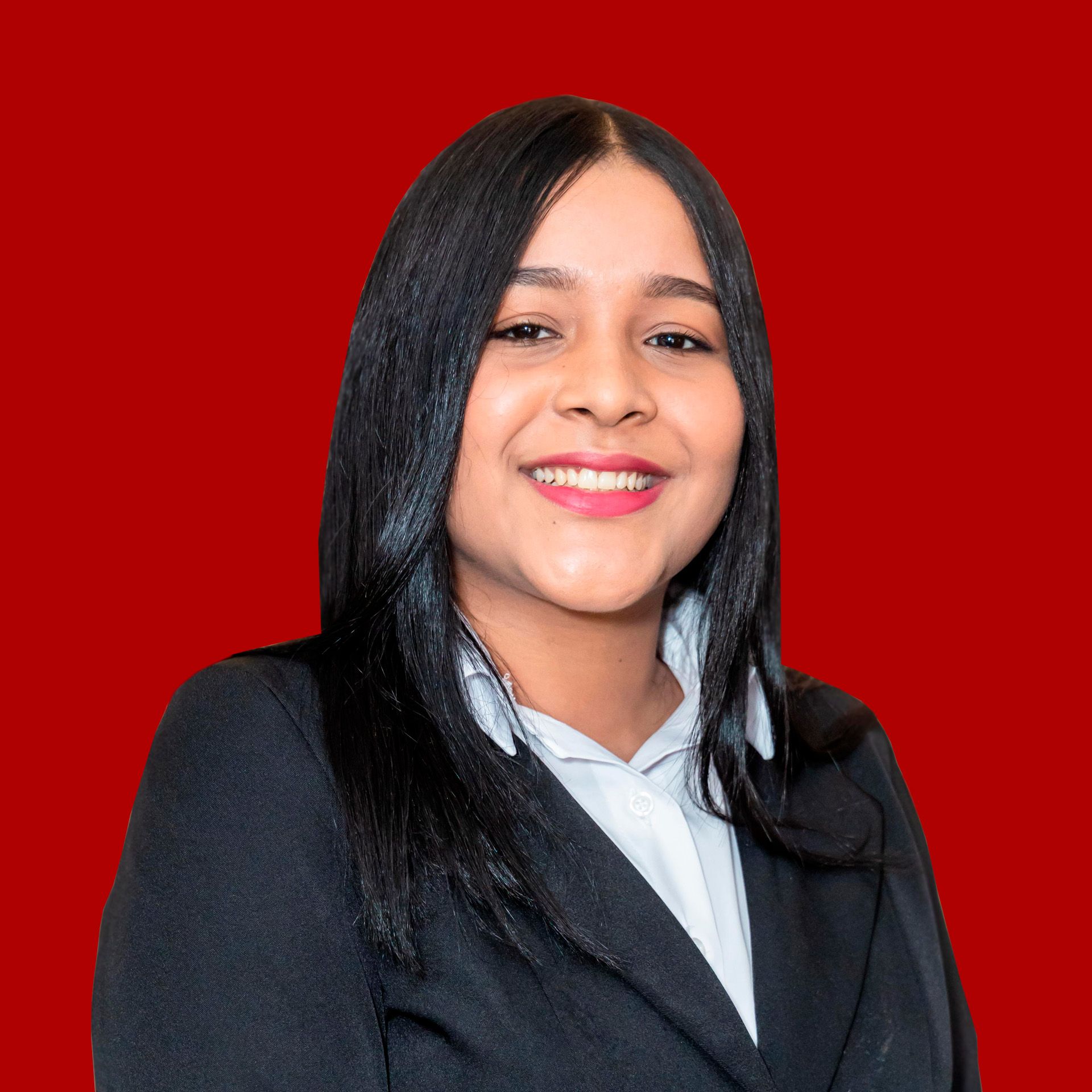 A woman in a black suit and white shirt is smiling in front of a red background.