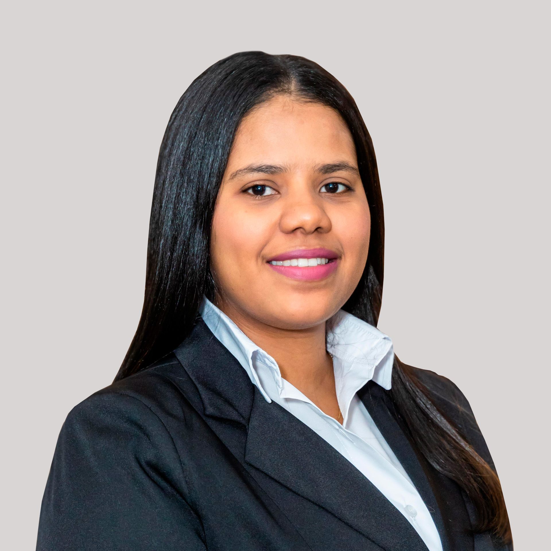A woman in a suit and white shirt is smiling for the camera.