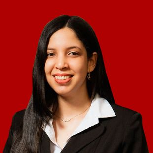 A woman in a black suit and white shirt is smiling