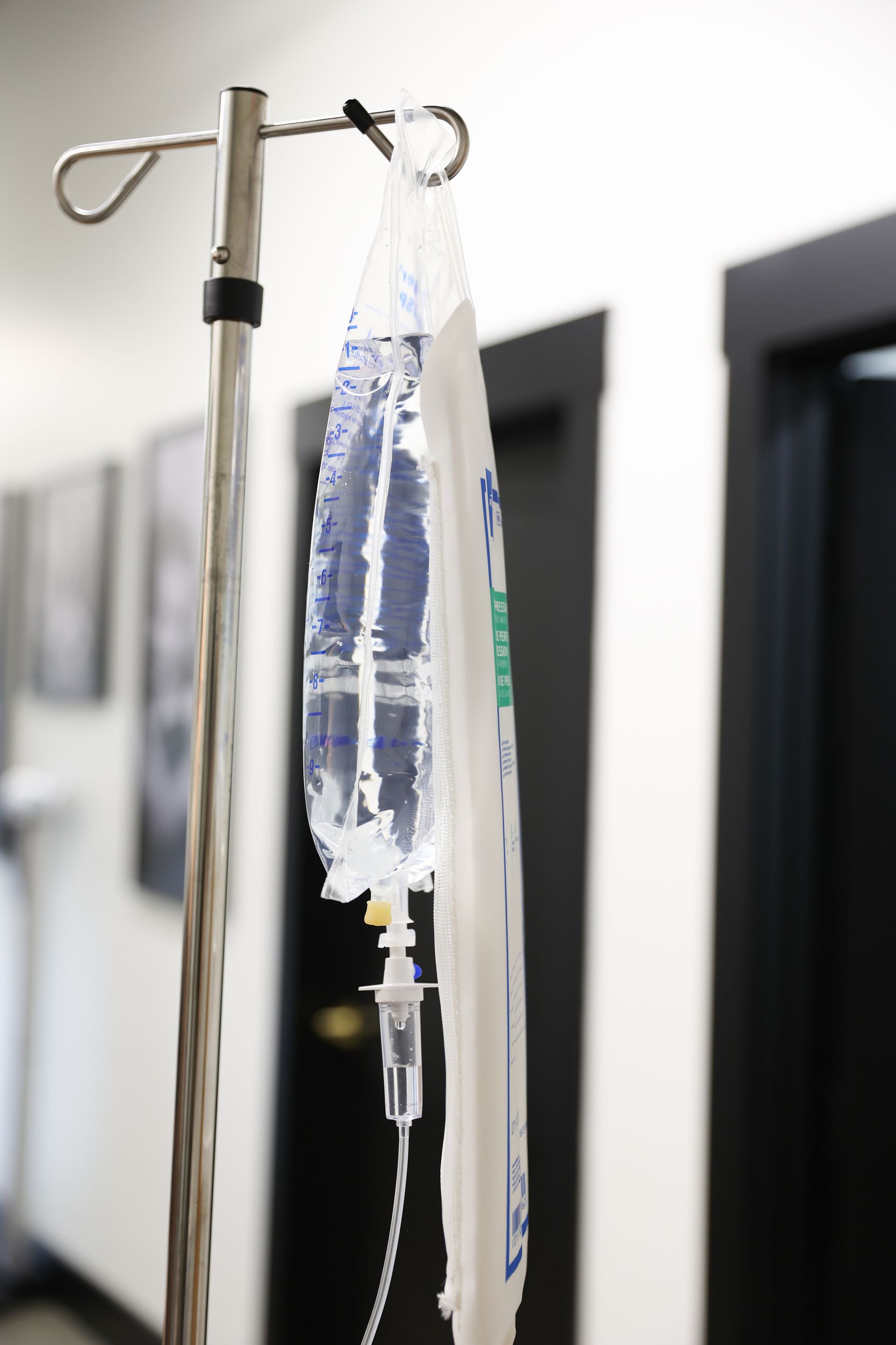 An iv bag is hanging from a pole in a hospital.