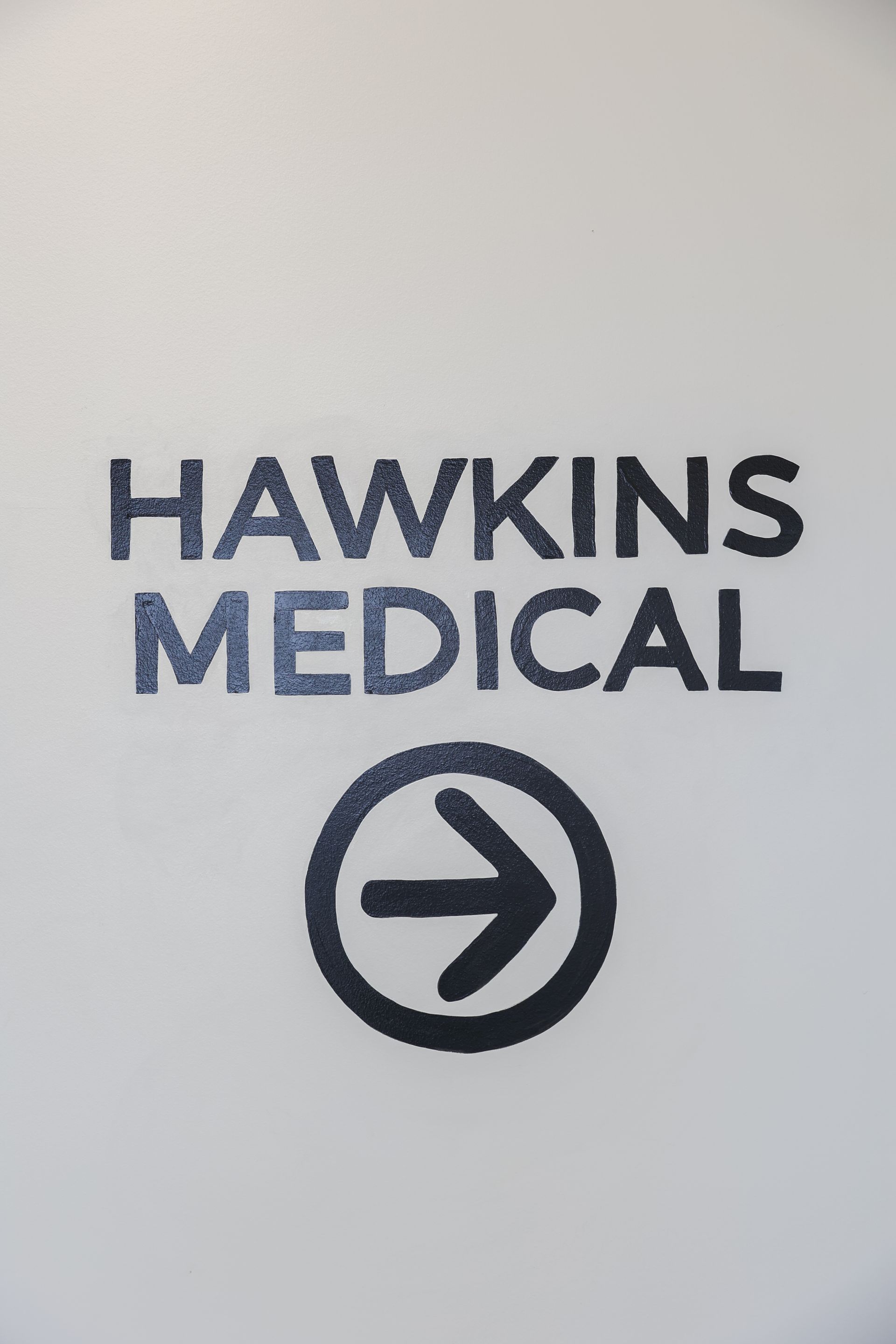 A sign for hawkins medical with an arrow pointing to the right