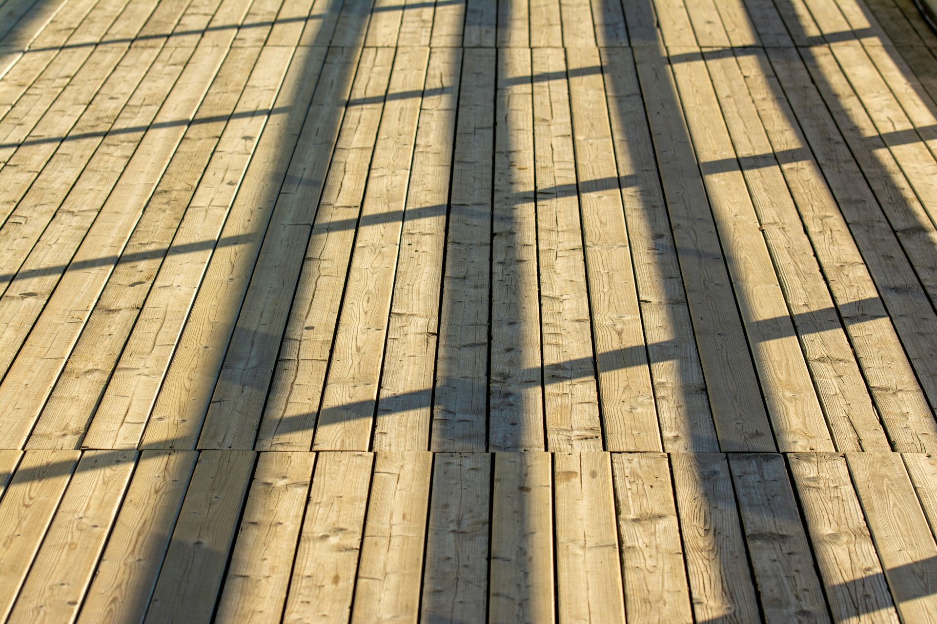 Close-up of white house eaves and guttering against blue-gray siding.