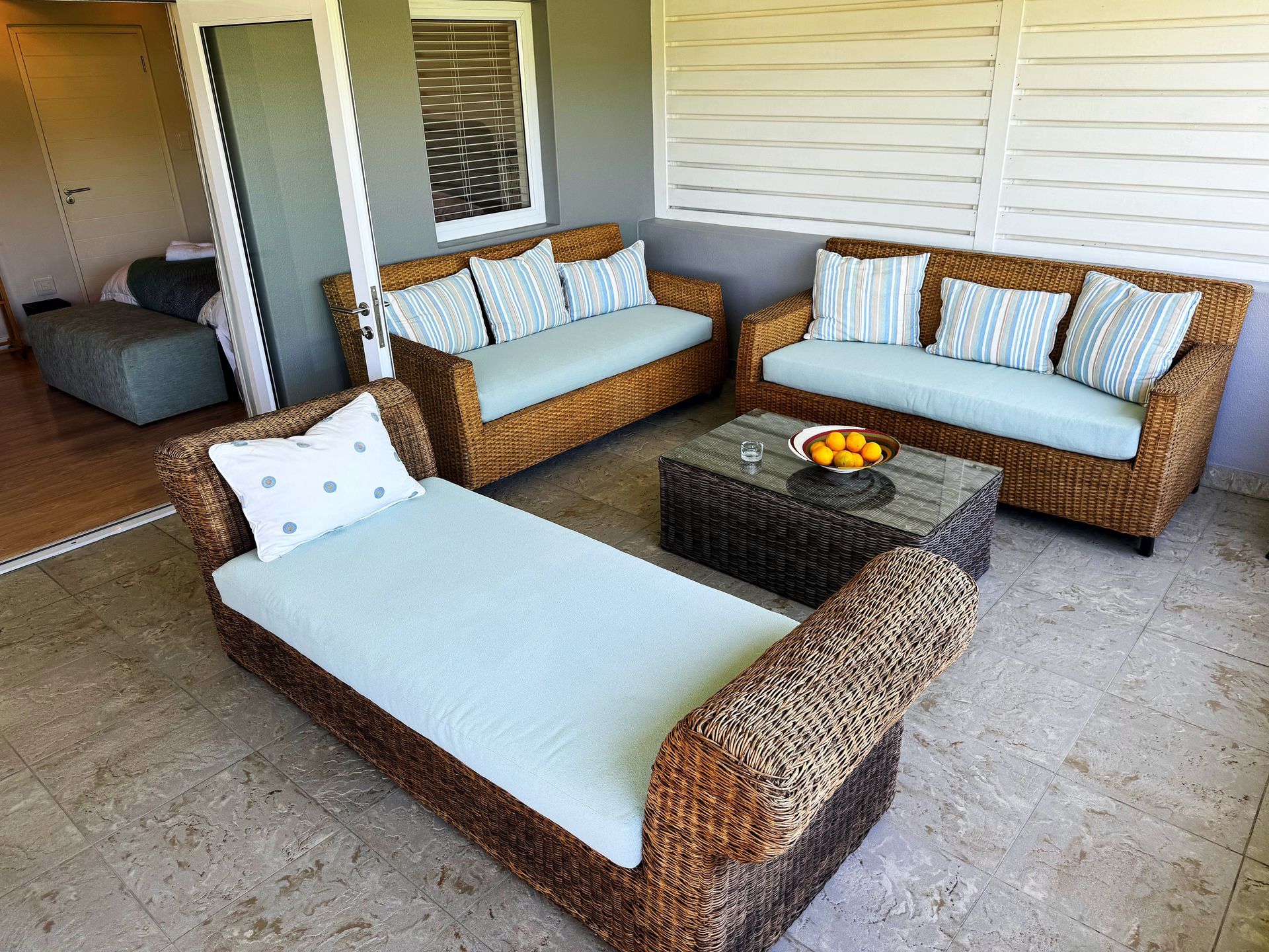 A living room with wicker furniture and a coffee table
