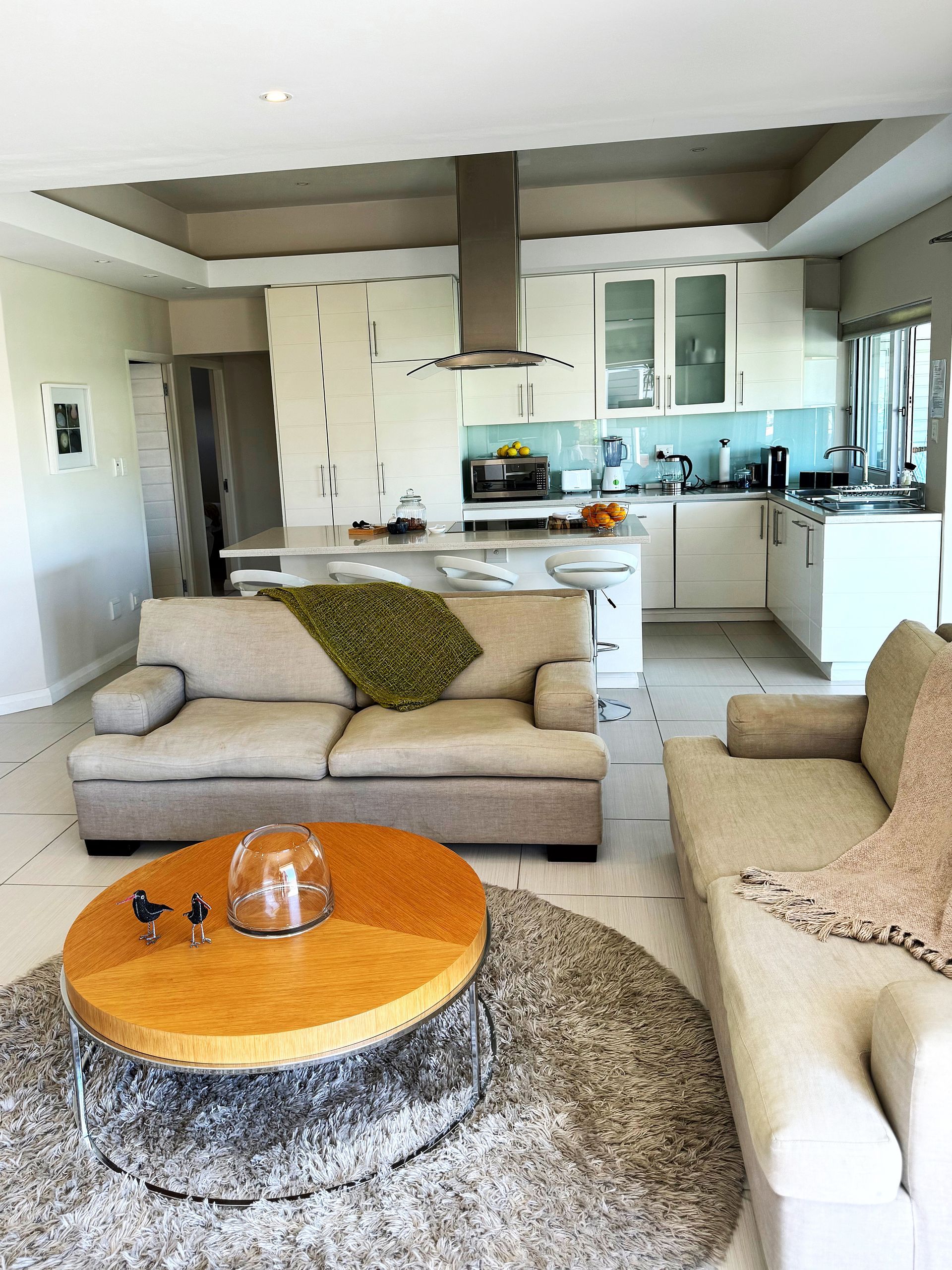 A living room with a couch and a round coffee table