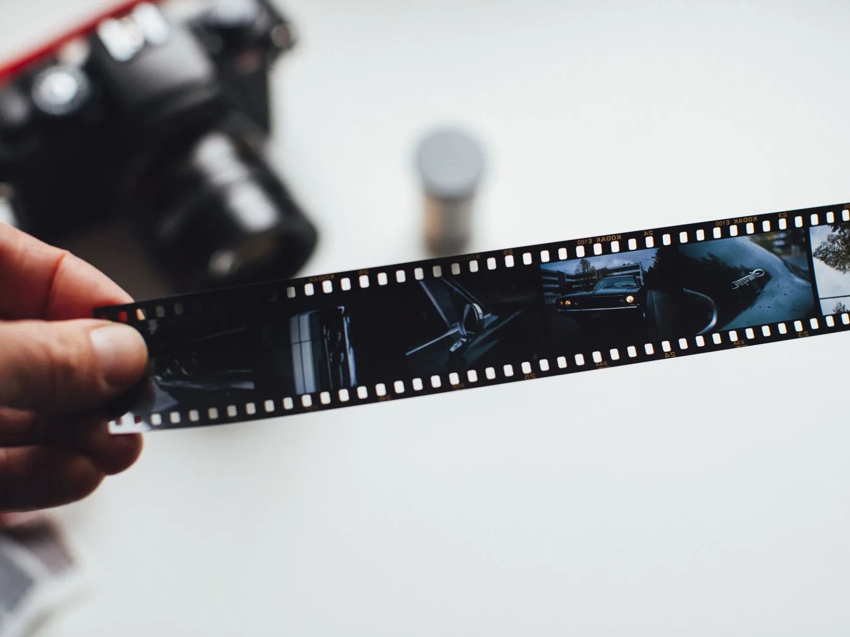 a person is holding a roll of film in their hand .