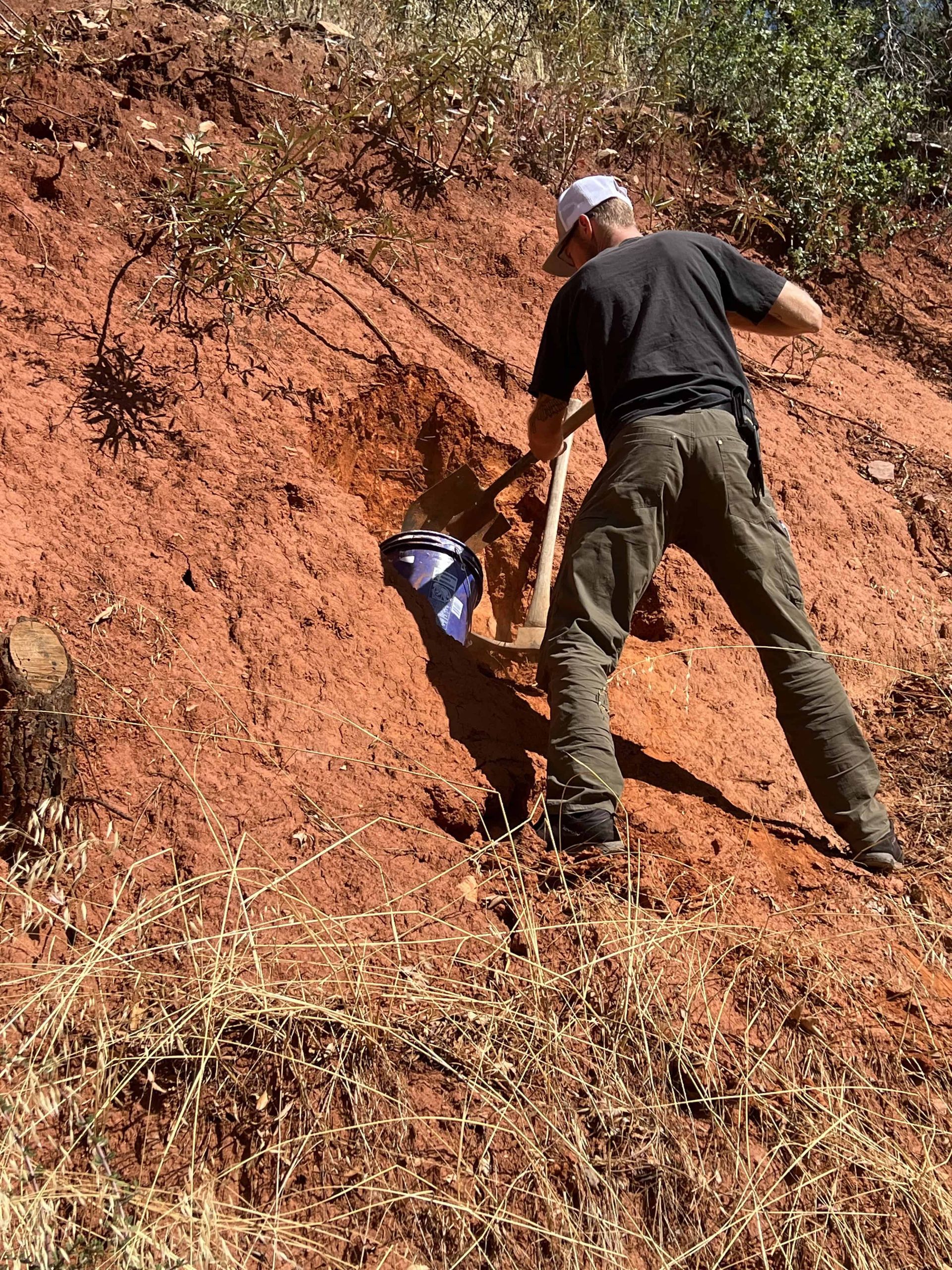 Student learning how to dig for terracotta to make pottery