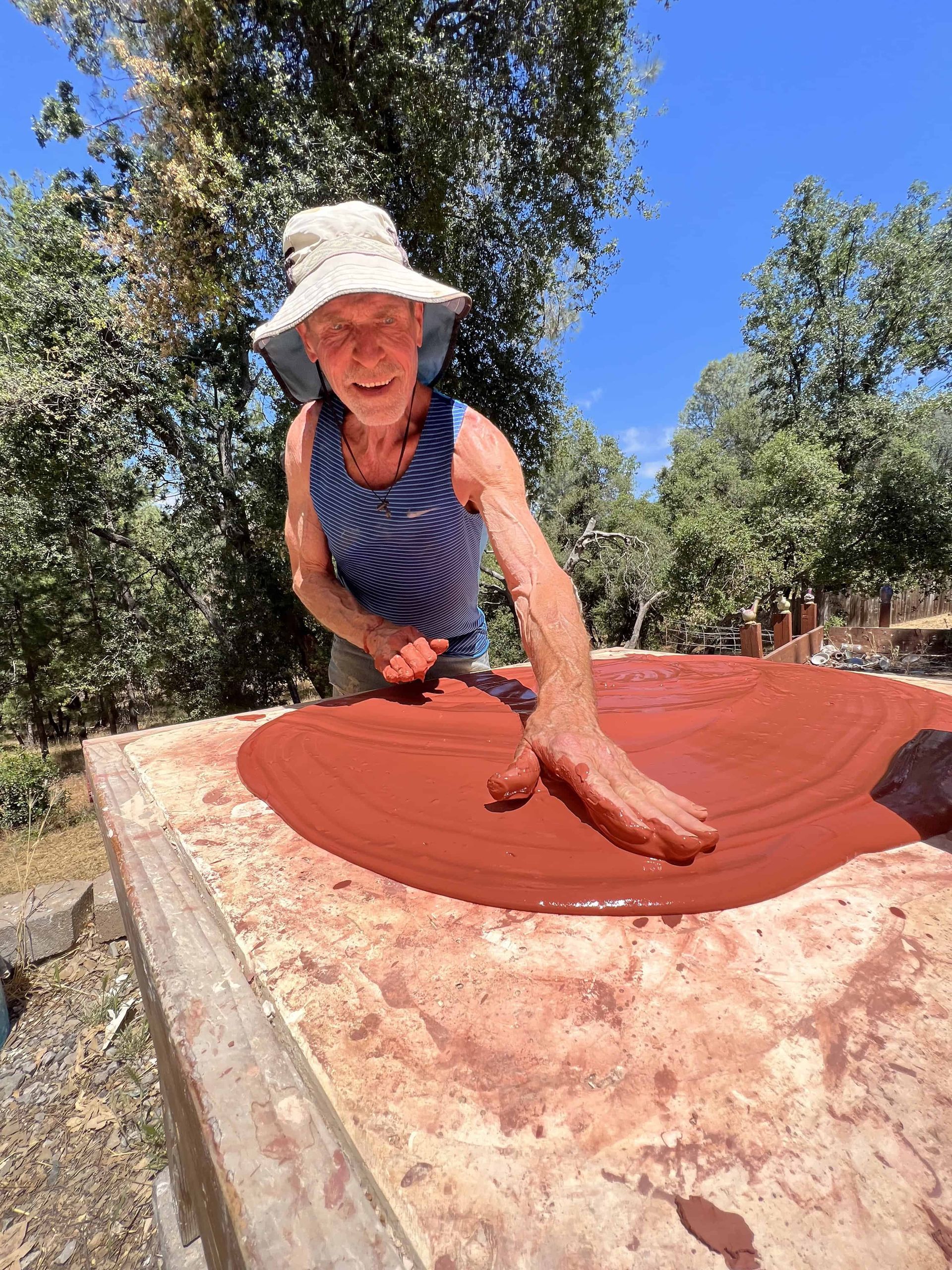 Bill showing students how to make terracotta, smoothing it out flat with water