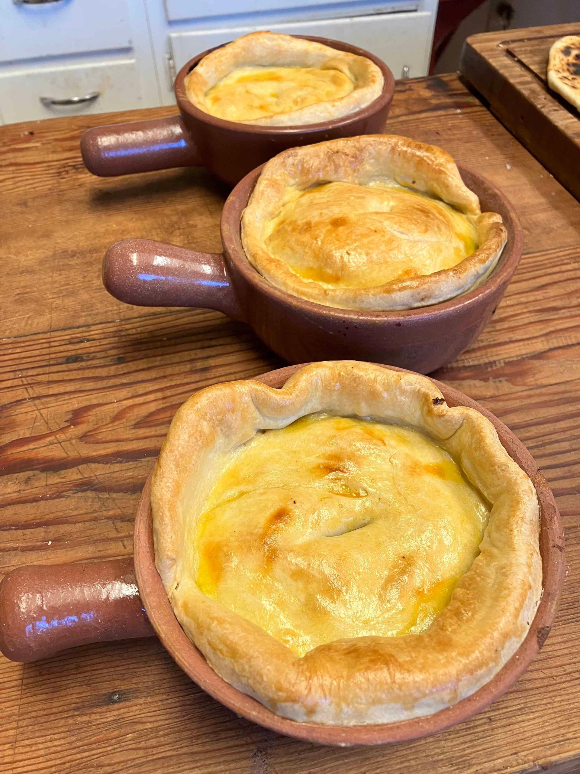 Cooked pies in two small terracotta pots