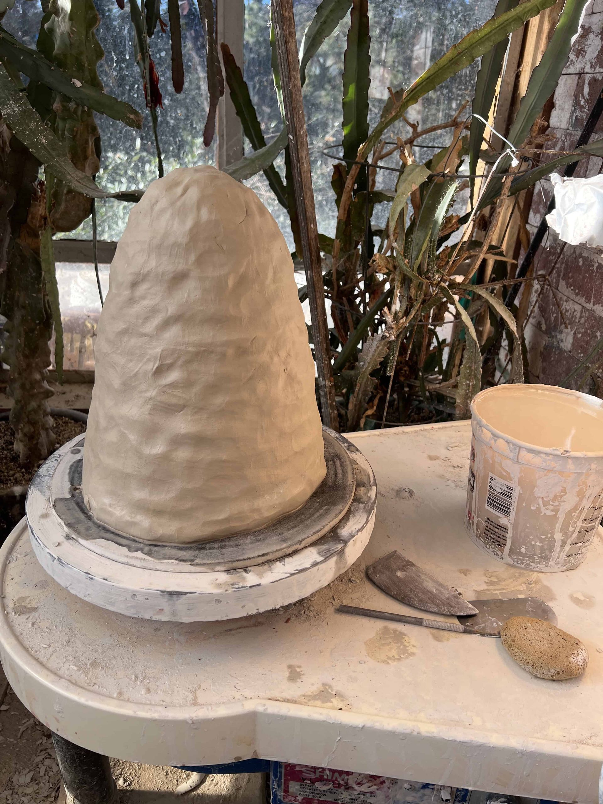 20 pounds of white stoneware clay on potters wheel being centered to make the sink