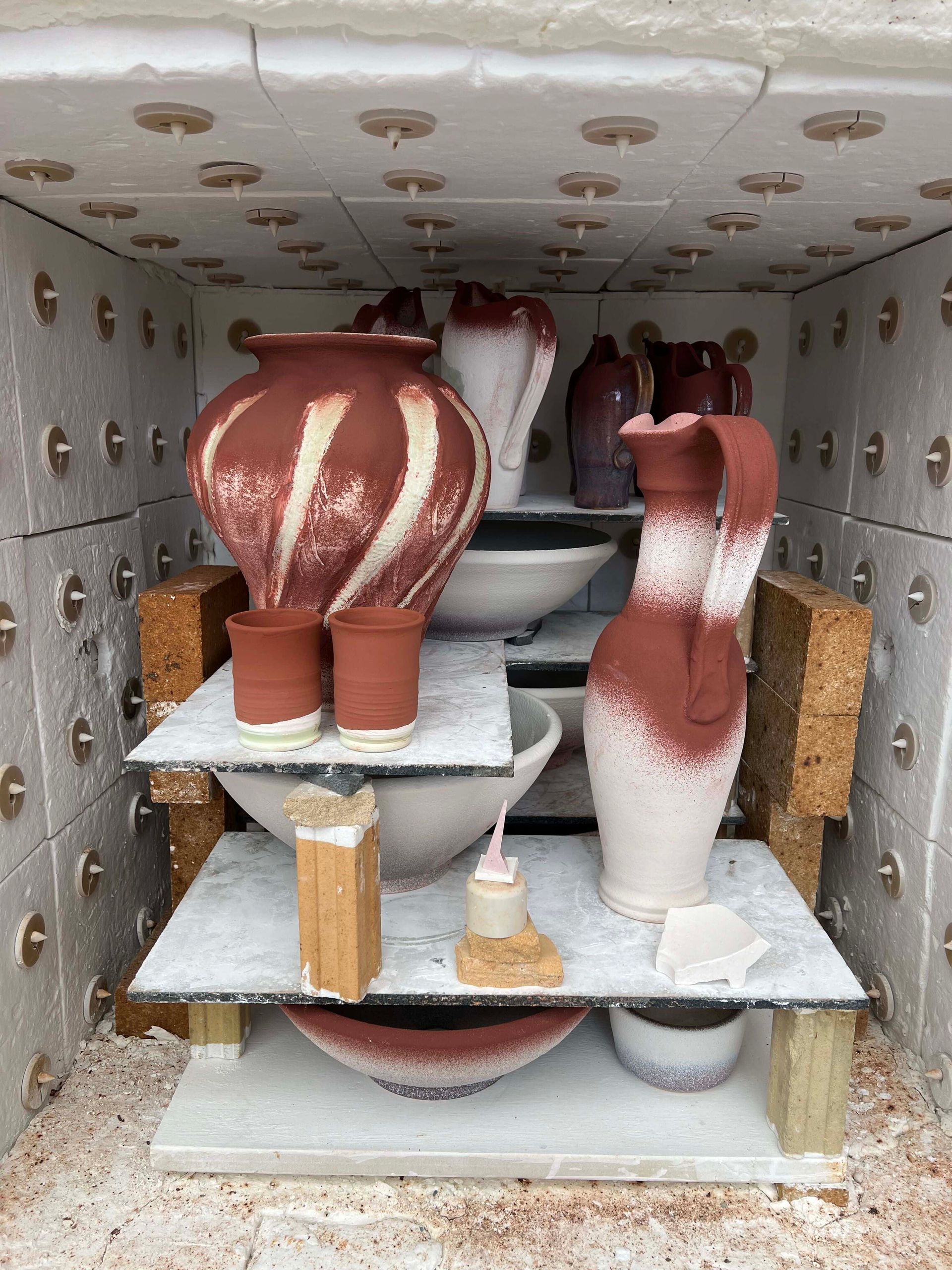 A Kiln full of pottery pieces that are ready to be fired.
