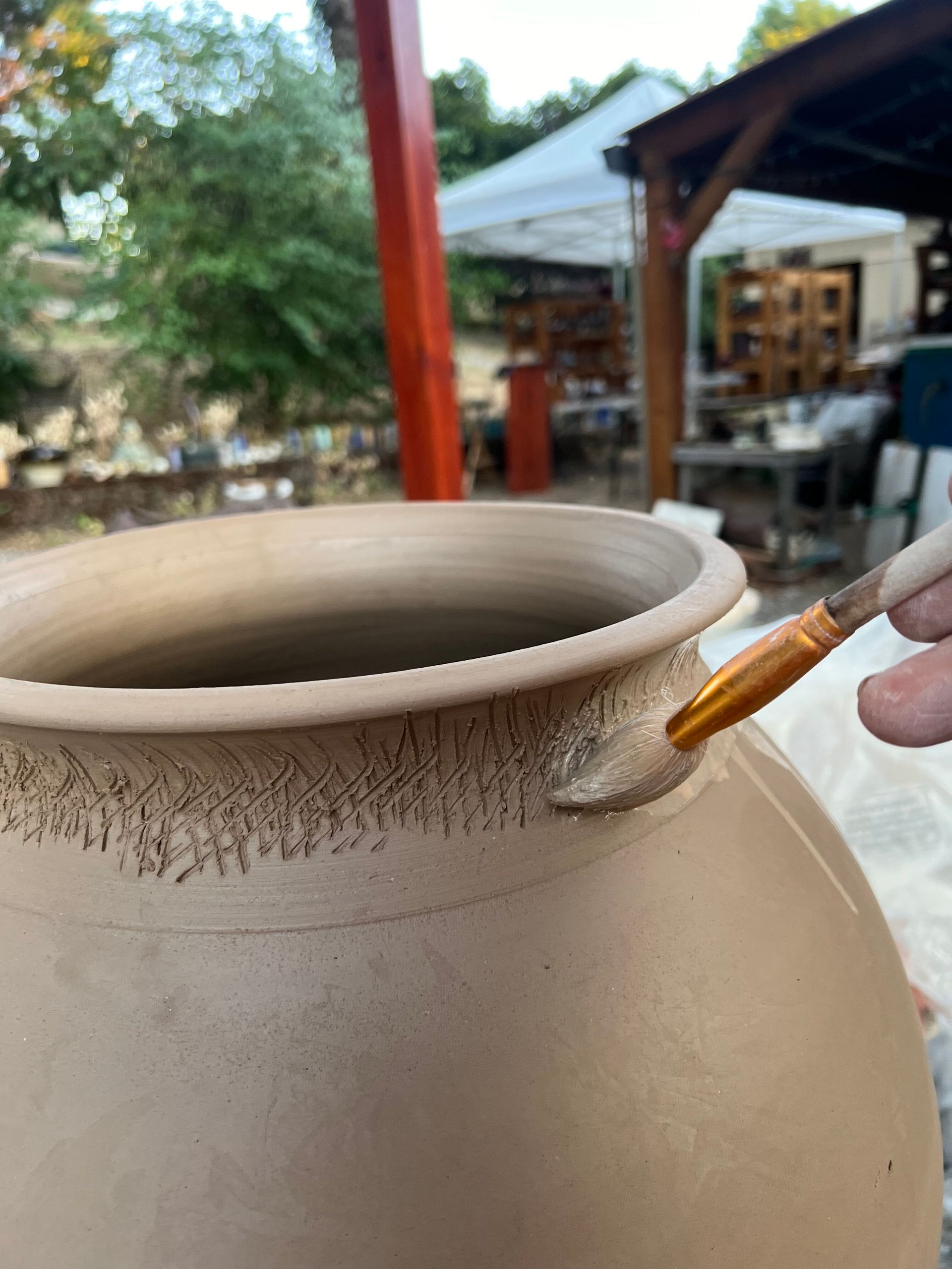 After throwing the bottom into the to I score and slip for attaching the decoration