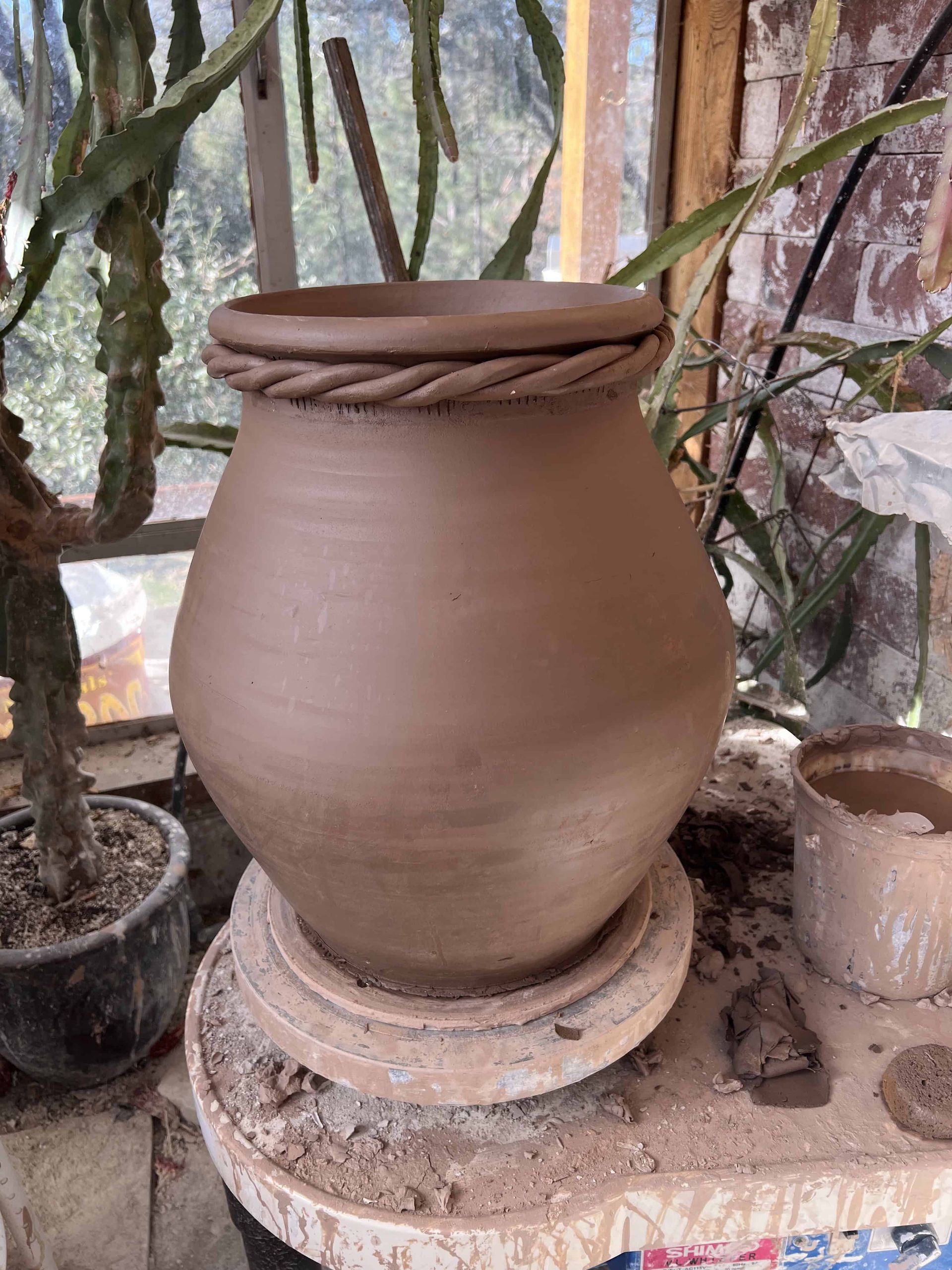 Rain catcher with braided clay rope on rim