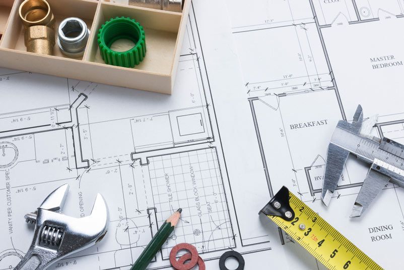 Plumbing Parts Laid on an Architecture Plan — Plumbing in Wollongong