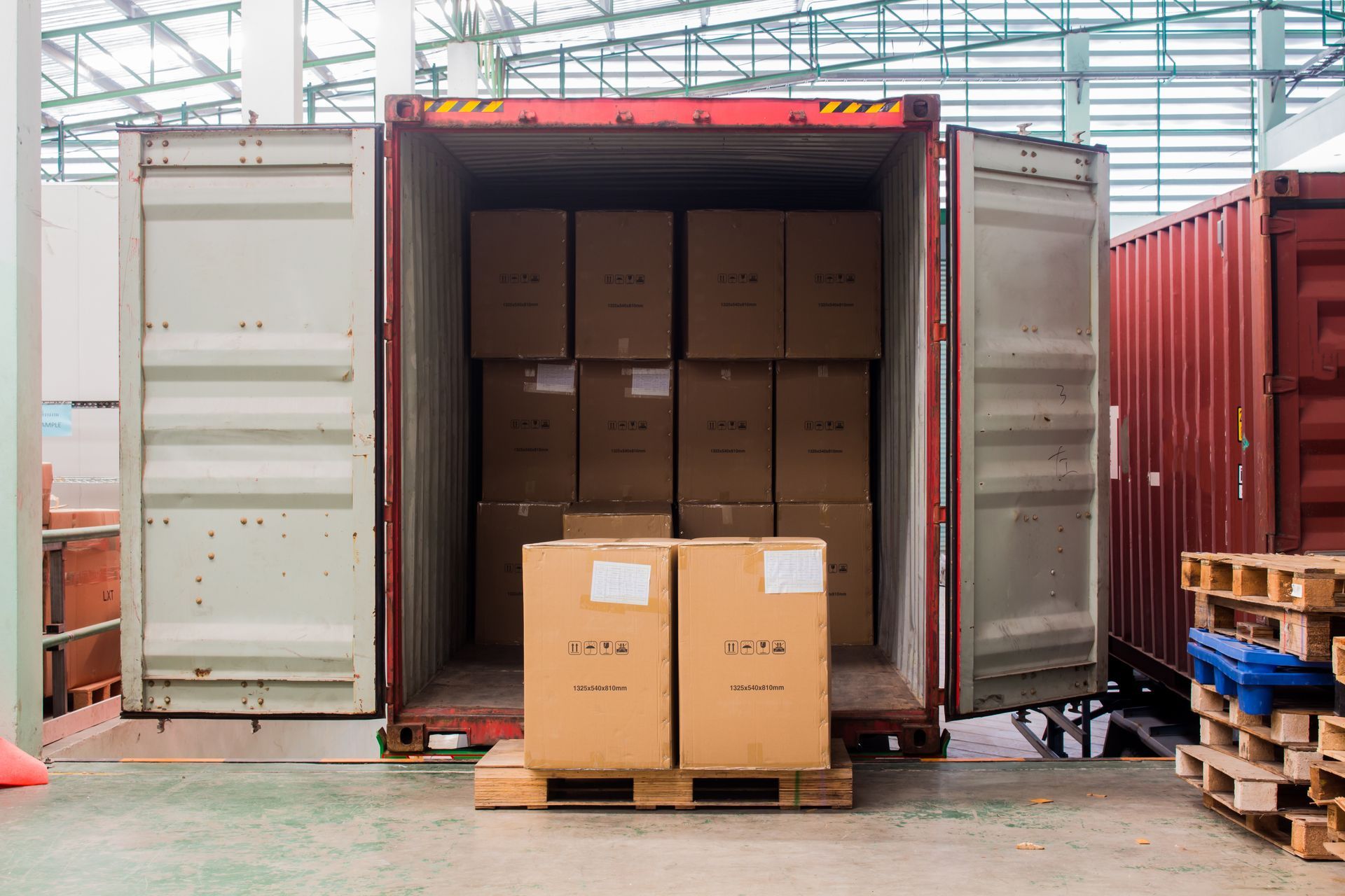 Storage container being unloaded on a delivery dock Storage container being unloaded on a delivery dock