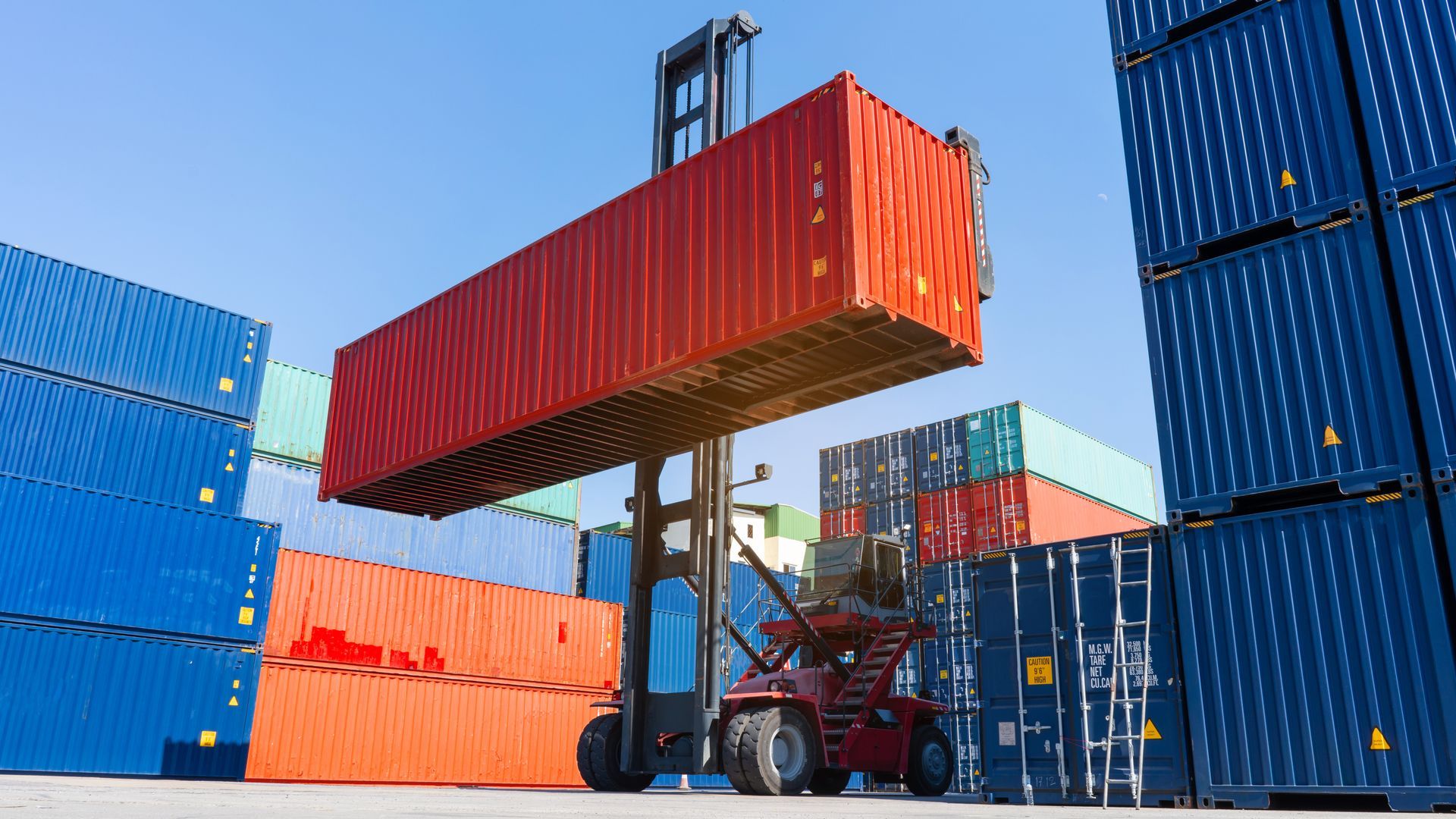 Forklift working in the container cargo yard port loading cargo tank logistic service. Forklift working in the container cargo yard port loading cargo tank logistic service.