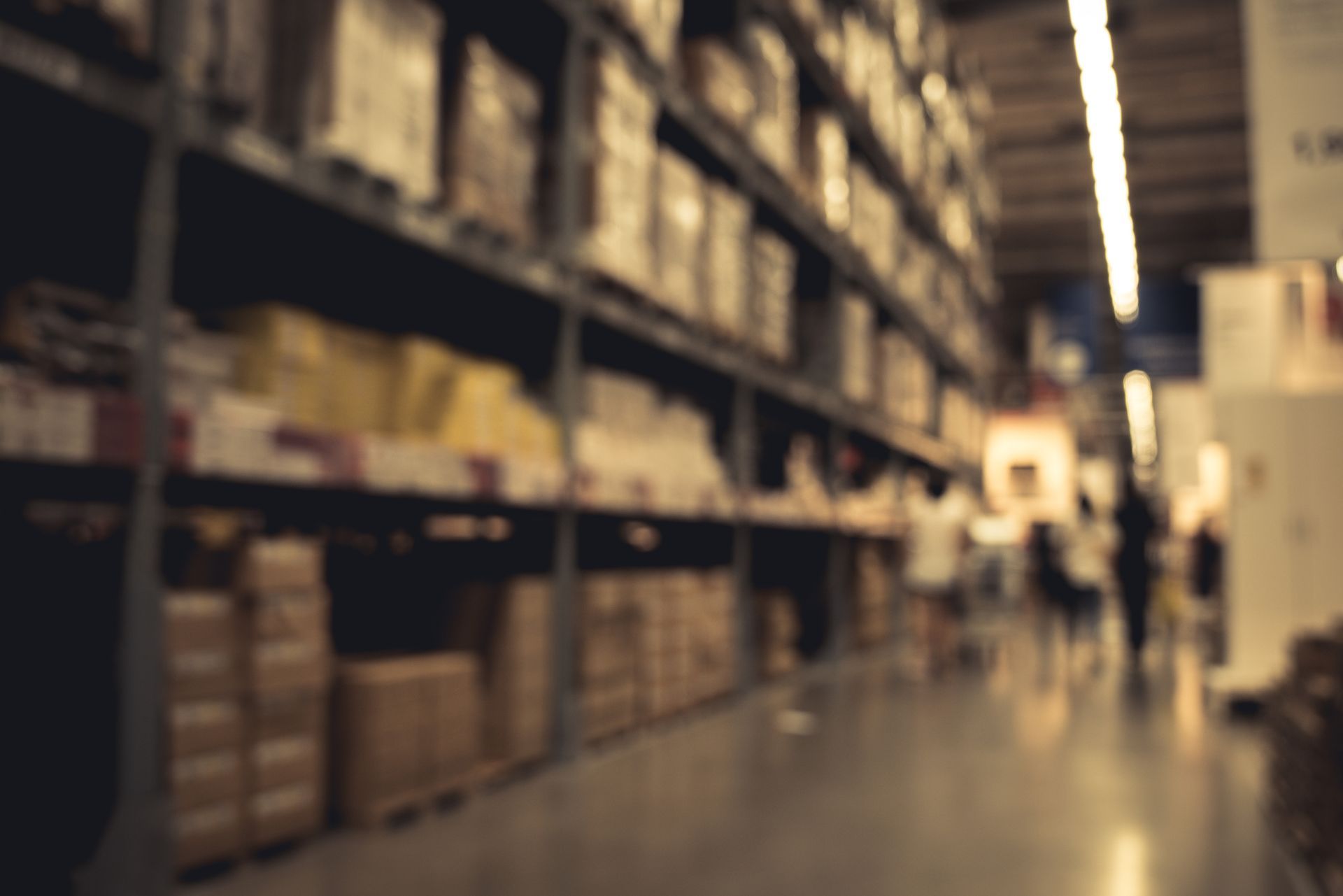 Unfocused and blurry picture of a storage building, with boxes on platforms.