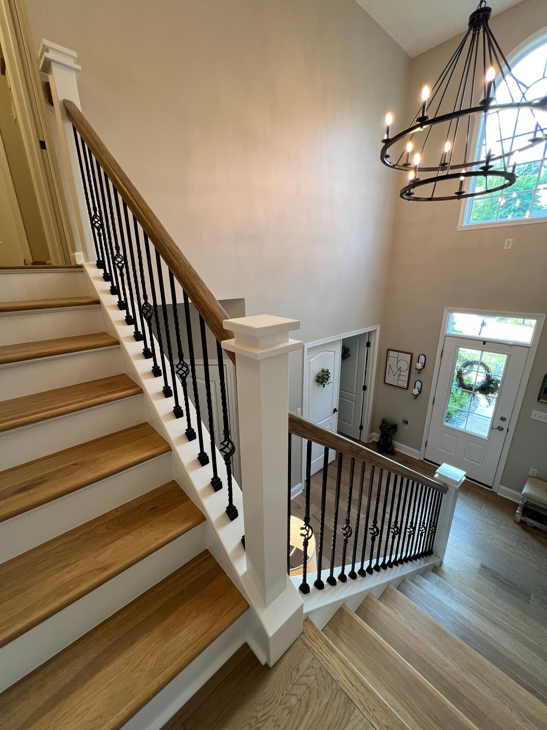 A staircase with wooden steps and a wrought iron railing in a house.