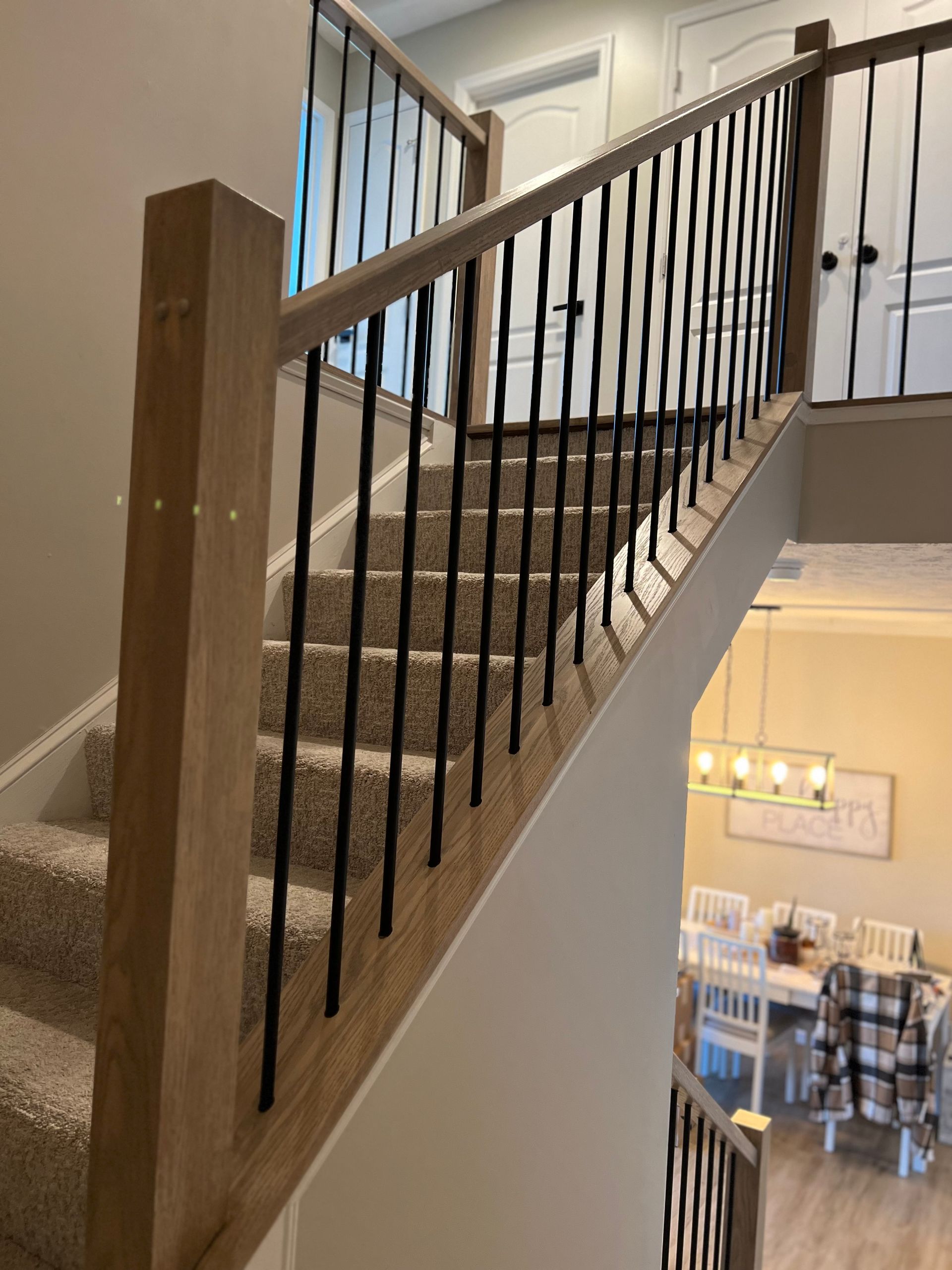A staircase in a house with a wooden railing