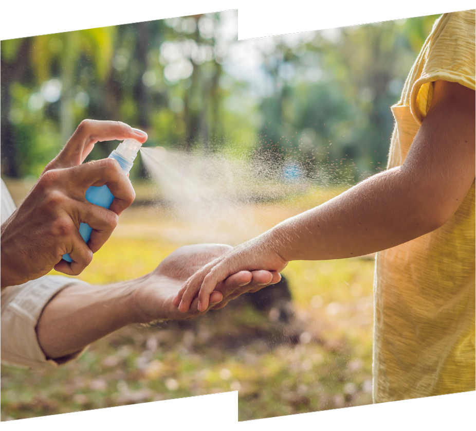 a person is spraying insect repellent on a child 's arm .