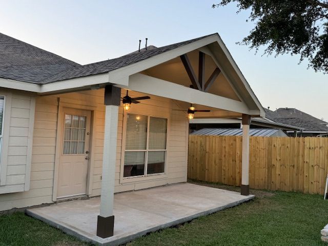 There is a grill and a refrigerator in the backyard.
