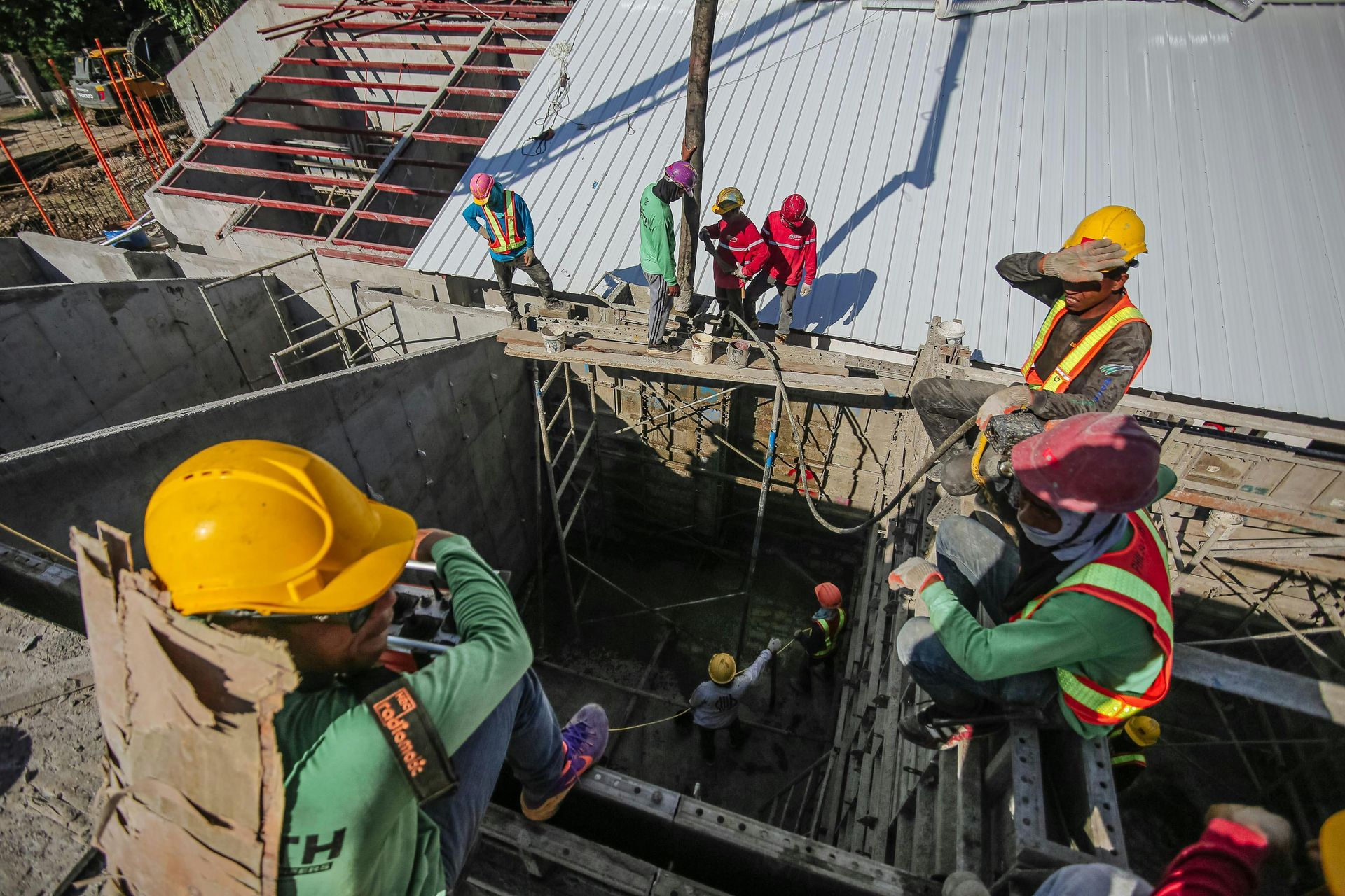A group of construction workers are working on a bridge.
