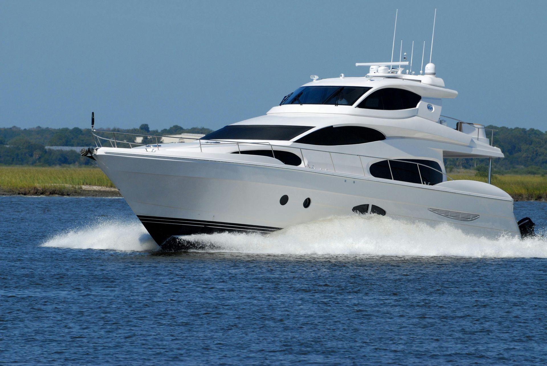 A large white yacht is floating on top of a body of water
