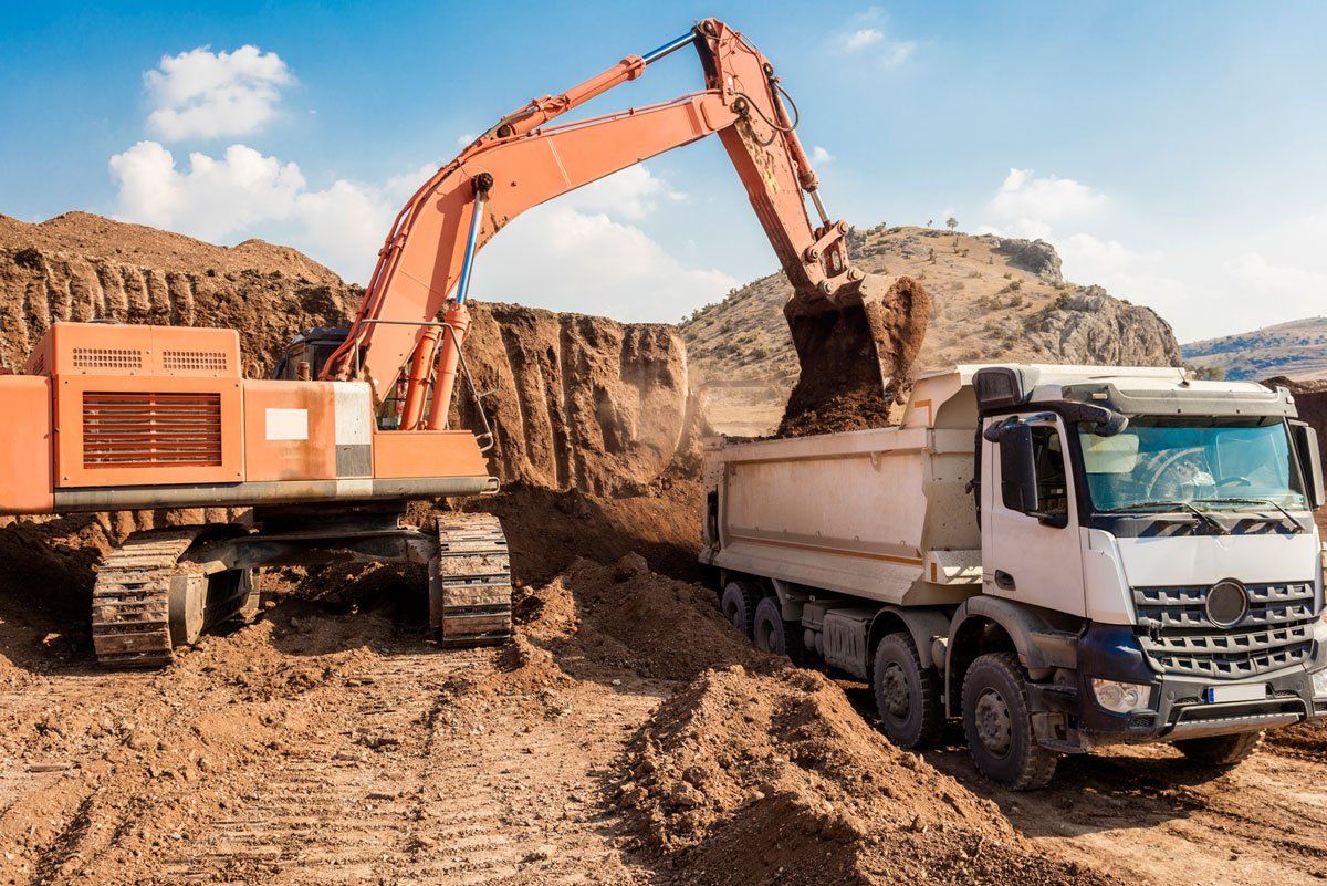 Excavator loading dumper trucks — North Kingsville, OH — Simak Trucking & Excavating, Inc.