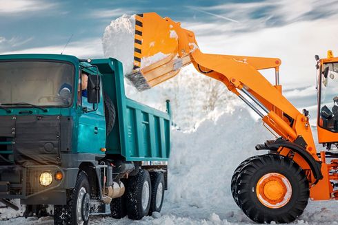 Excavator loading snow into a truck — North Kingsville, OH — Simak Trucking & Excavating, Inc.