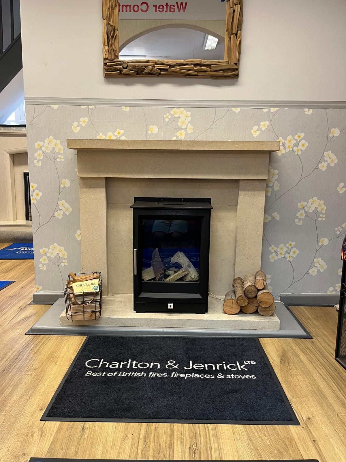 A fireplace with a rug that says charlton & jennick on it